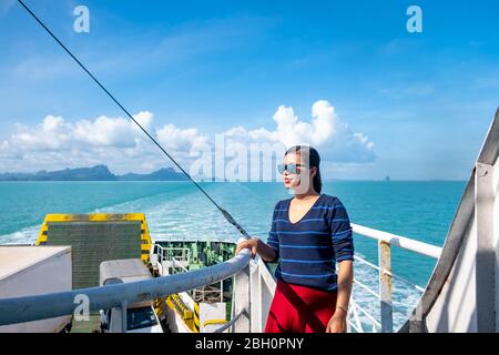 Close up portrait Happy thai woman enjoying the sea from ferry. summer, holidays, vacation, travel and active lifestyle concept Stock Photo