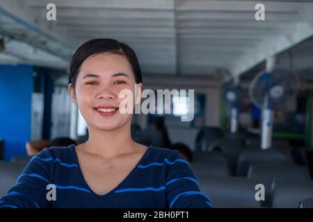 Close up portrait Happy thai woman enjoying the sea from ferry. summer, holidays, vacation, travel and active lifestyle concept Stock Photo