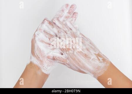 personal hygiene. washing hands, rubbing hand thoroughly with soap that has a lot of bubbles for cleaning and disinfection, prevention of spreading of Stock Photo