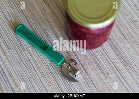 can of canned borscht with a hand-held can opener. Stock Photo