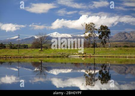 Ceres mountains covered in snow in a water reflection Stock Photo