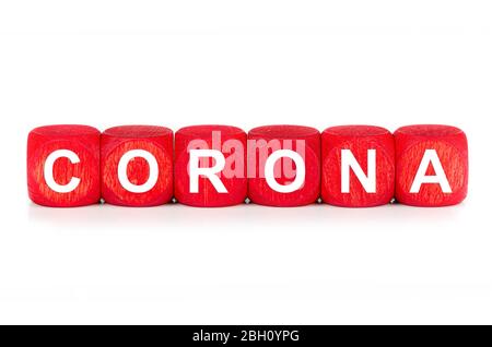 term CORONA - built from red wooden cubes on white background, isolated Stock Photo