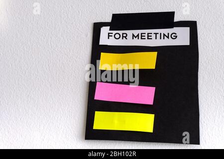 ragged note paper and stripe of adhesive tape on white wall Stock Photo