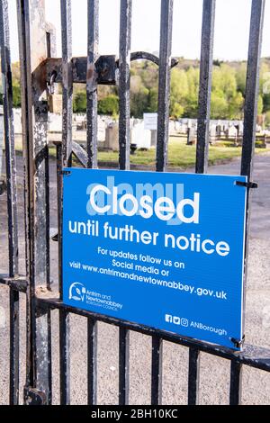 Northern Ireland, UK. 24 April 2020 - Sign outside a cemetery advising the public that it is closed due to Covid-19.   Health Minister Robin Swann is under public and legal pressure to reopen cemeteries in Northern Ireland which have been forced to close to visitors, with the exception of funerals, due to Covid-19.  Relatives are upset that they are unable to visit graves of recently deceased people. Credit: Stephen Barnes/Alamy Live News Stock Photo