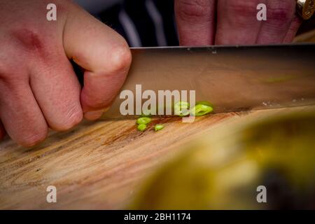 A chef prepares Nepalese dishes in a kitchen. Stock Photo