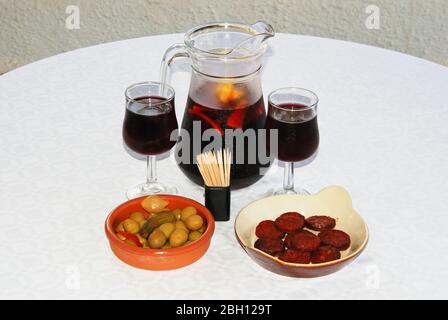 A selection of tapas with a jug of Sangria, Sliced Chorizo sausage and green olive cocktail, Costa del Sol, Malaga Province, Andalucia, Spain, Western Stock Photo