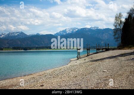 the lake 'forggensee' is a reservoir located in south germany. Due to the hydroelectric power station there is not much water in the lake in winter an Stock Photo