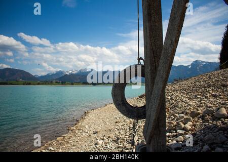 the lake 'forggensee' is a reservoir located in south germany. Due to the hydroelectric power station there is not much water in the lake in winter an Stock Photo