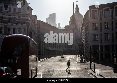 London, UK. 23rd Apr 2020. A lone commuter walks across Ludgate Circus early this morning in the City of London, as lockdown measures need to be eased out in the next three to four weeks amid coronavirus for the economy to recover. City of London lockdown, England, United Kingdom 23rd April, 2020 Credit: Jeff Gilbert/Alamy Live News Stock Photo