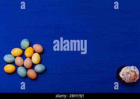 multi-colored eggs for the Easter holiday on a blue background Stock Photo