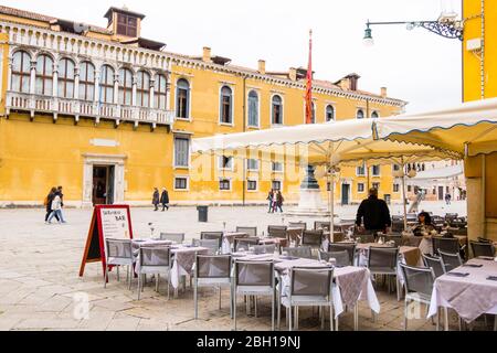 Restaurant terrace, with Palazzo Loredan in background, Campo Santo Stefano, San Marco, Venice, Italy Stock Photo