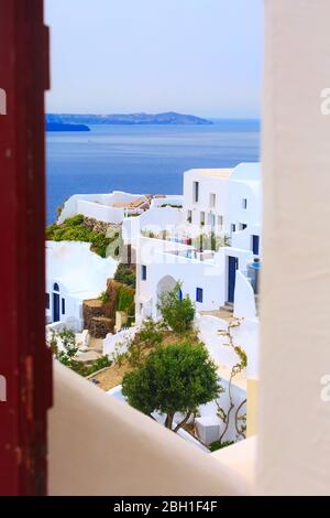 Santorini, Greece white houses architecture, hotels with caldera blue sea view through the open door Stock Photo