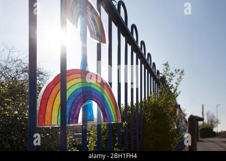 Rainbow picture on a school fence railing in England about NHS Stay Safe Coronavirus Covid-19 Stock Photo