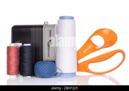 Thread spools with scissors and sharpener isolated on white Stock Photo
