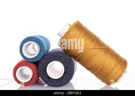 Group of three whole thread spools isolated on white Stock Photo