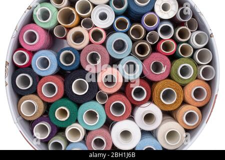 Lot of whole colourful thread spools isolated on white Stock Photo