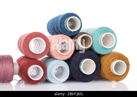 Group of four whole thread spools isolated on white Stock Photo