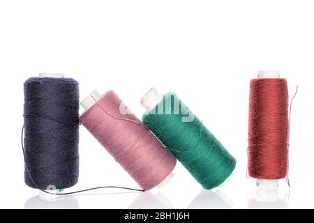 Group of four whole thread spools for sewing isolated on white Stock Photo
