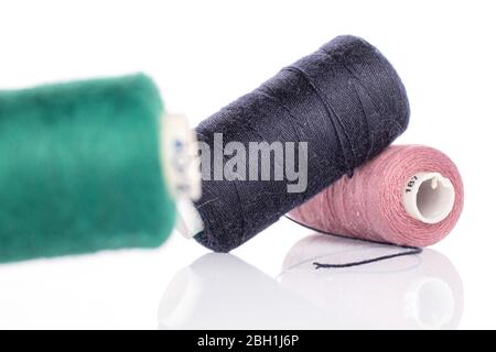 Group of three whole thread spools for sewing isolated on white Stock Photo