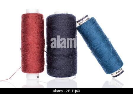 Group of three whole thread spools isolated on white Stock Photo
