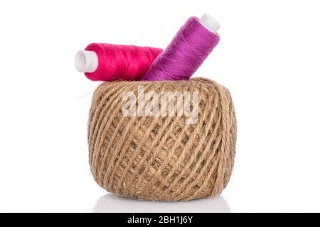 Group of three whole beige purple pink thread spools isolated on white Stock Photo