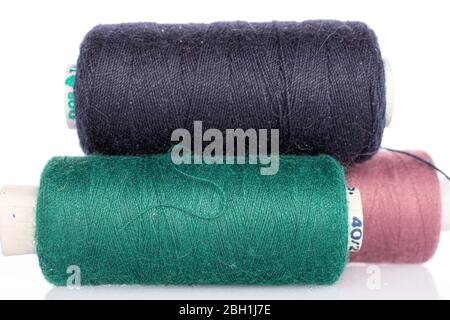 Group of three whole thread spools closeup isolated on white Stock Photo