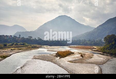 Foggy Mountains and river at Himalayas near Pokhara in Nepal Stock Photo