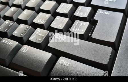 Closeup of black keyboard keys. Selective focused on foreground, shift key. Stock Photo