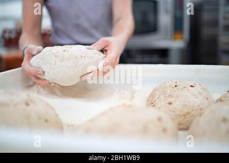 Close-up of woman preparing bread in bakery Stock Photo