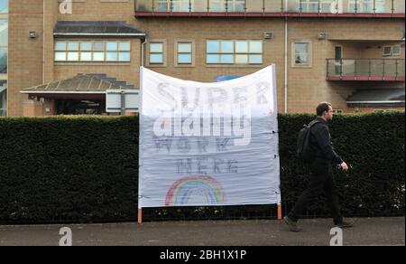 In the midst of the coronavirus pandemic a huge home-made sign has appeared outside Cheltenham General Hospital saying 'Superheroes work here' Stock Photo