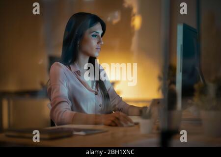Young woman working at desk in office Stock Photo