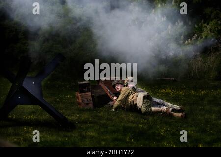 WW2 soldiers on the battlefield reenacting battle scenes with guns and ...
