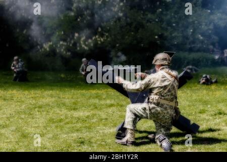 WW2 soldiers on the battlefield reenacting battle scenes with guns and ...