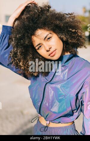 Portrait of stylish young woman wearing tracksuit outdoors Stock Photo