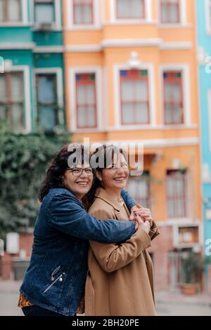 Portrait of happy mother hugging adult daughter on the street, Istanbul, Turkey Stock Photo