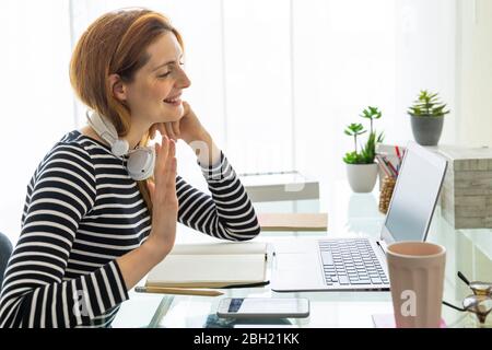 Young woman having a video conference at home Stock Photo