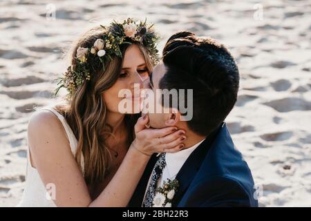 Happy bridal couple kissing each other Stock Photo