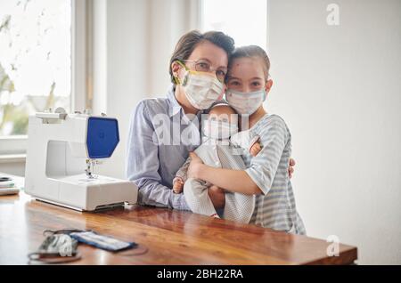 Little girl and her doll, wearing face masks, her mother has made for them Stock Photo
