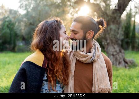 Happy young couple kissing in the countryside
