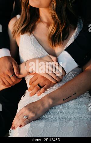 Close up of bridal couple holding hands Stock Photo