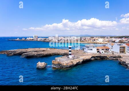 Spain, Balearic Islands, Colonia de Sant Jordi, Coastal lighthouse with city in background Stock Photo