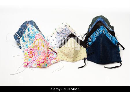 Colorful (DIY) homemade cloth facial masks for protection against coronavirus (COVID-19). Masks for men, women and children. Stock Photo