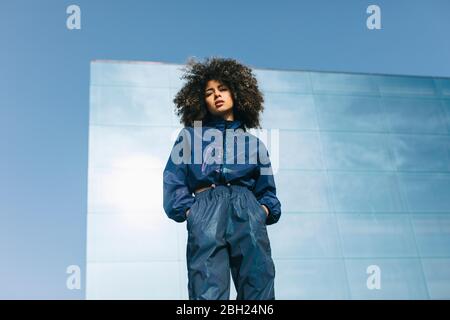 Portrait of stylish young woman wearing tracksuit outdoors Stock Photo