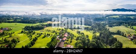 Aerial Bad Toelz Bavarian Alps. Golf Course. Blomberg Mountain. Morning Drone Shot with some clouds in the sky Stock Photo