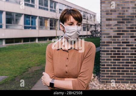 Portrait of woman wearing mask outdoors Stock Photo
