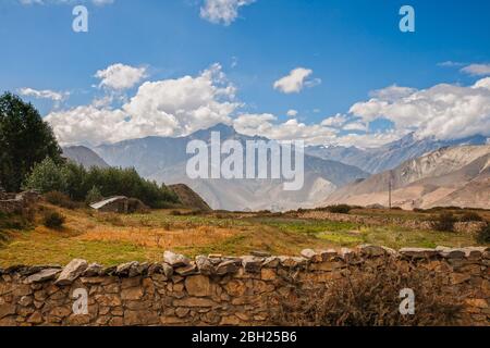 Himalayan landscape, fields and gardens behind stone fences at the foot of the mountains, Lower Mustang, Nepal. Stock Photo