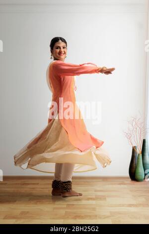 Beautiful kathak dancer performing at home. Stock Photo