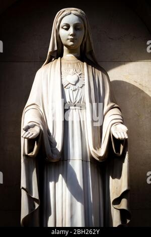 Statue of the Holy Mother Mary holding out her hands Stock Photo