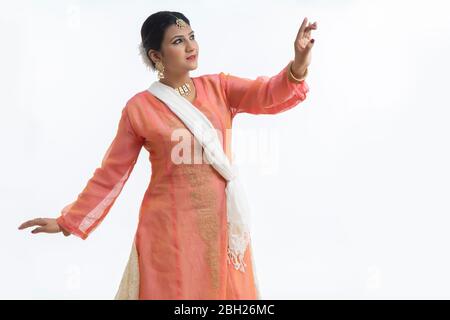 Beautiful kathak dancer performing in front of a white background. Stock Photo