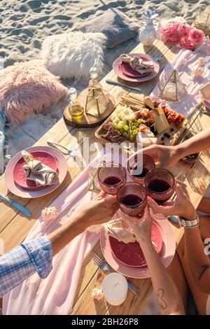 Luxury beach picnic close up with multiple people and a delicious set of food and wine. Riviera Nayarit, Mexico Stock Photo